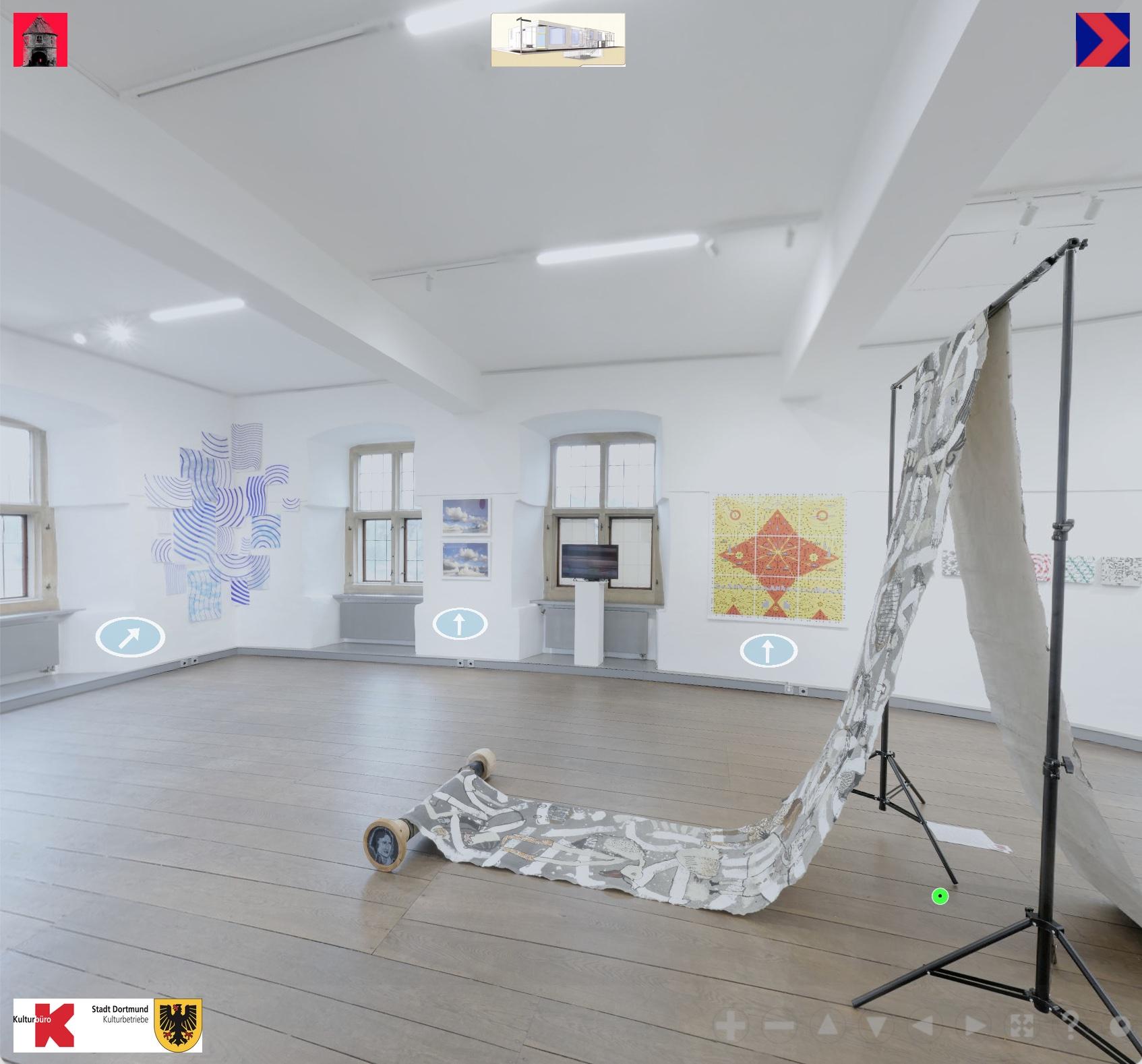 A room with white walls in which medieval windows are set. Green foliage can be seen through the windows. The room has a wooden floor made of thick dark brown planks. There are pictures hanging at the walls and sculptures standing in the room. In the foreground there's a long, painted canvas hanging down from both sides of a background mount